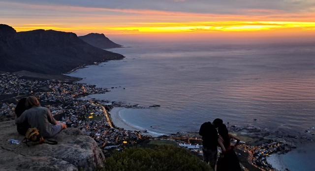 Two couples on lions head at sunset